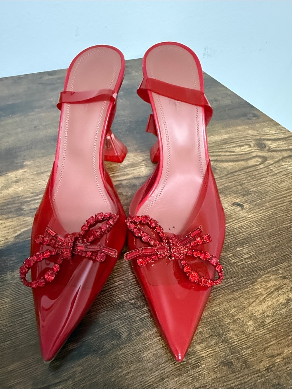 Amina Muaddi Red Pointed Slingback Heels with Embellished Bow